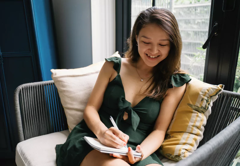 a girl writing in a journal