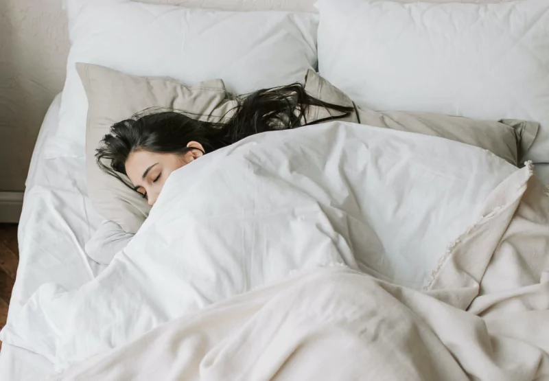 a girl laying in bed sleeping