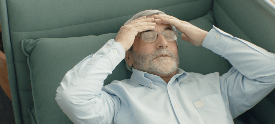 a man holding his head in pain