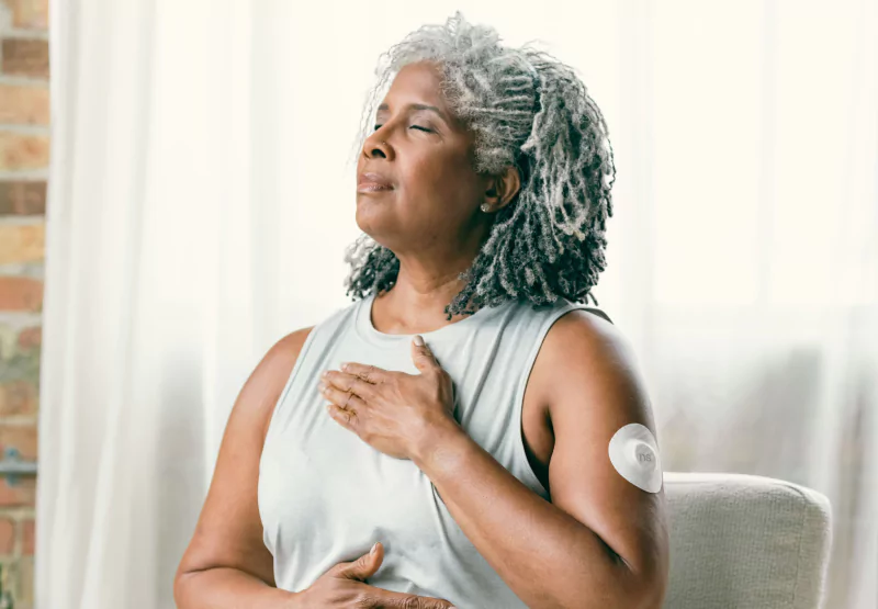 a woman wearig a CGM and meditating