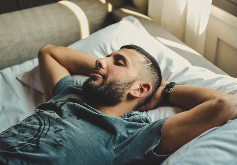 a man resting in his bed