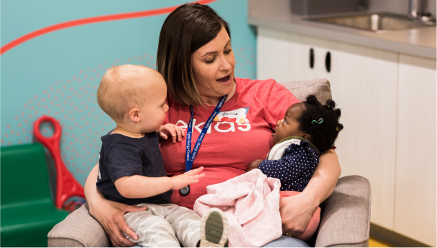 Woman holding two kids
