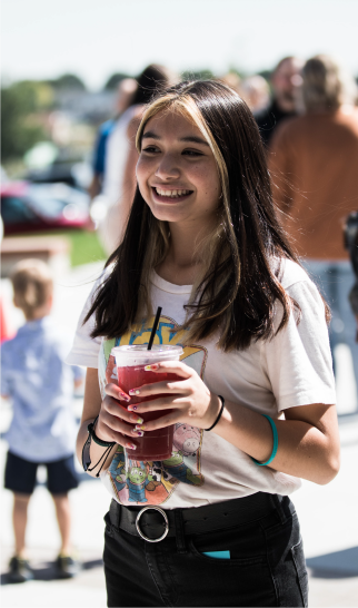 Girl smiling with smoothie in hand
