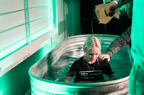 Girl in tub about to get baptized