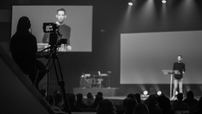 Person operating camera while pastor is on stage