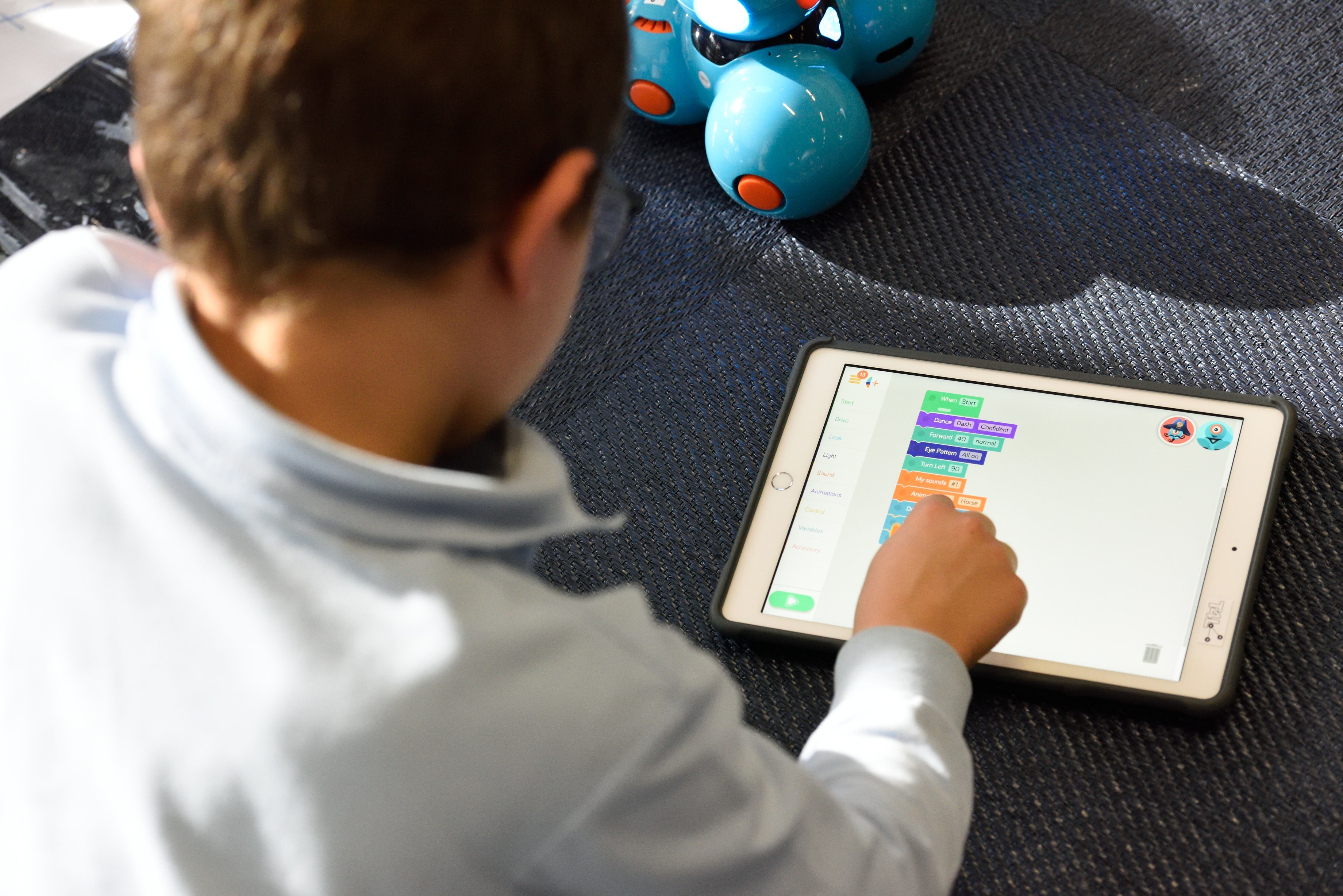 Boy coding on tablet