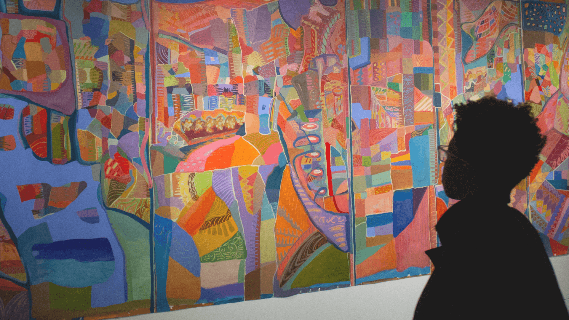 A person looking at art in an art gallery in MoAD