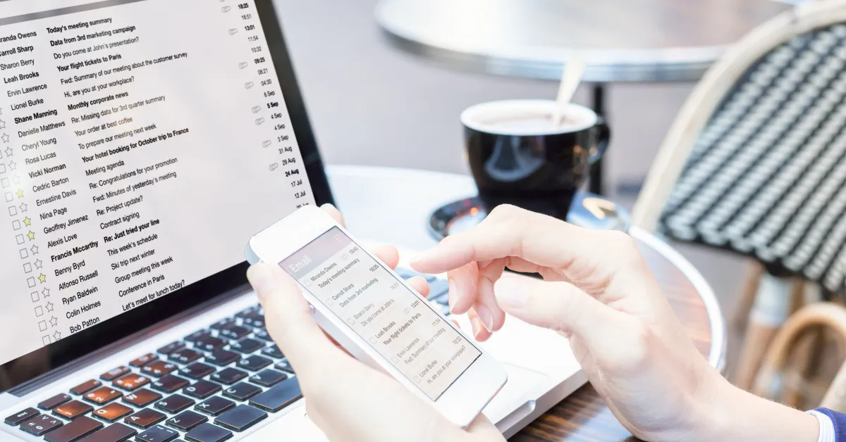 Close up of laptop and smartphone with email application open.
