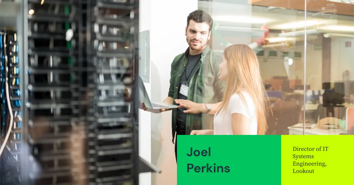Two people talking and working on servers.