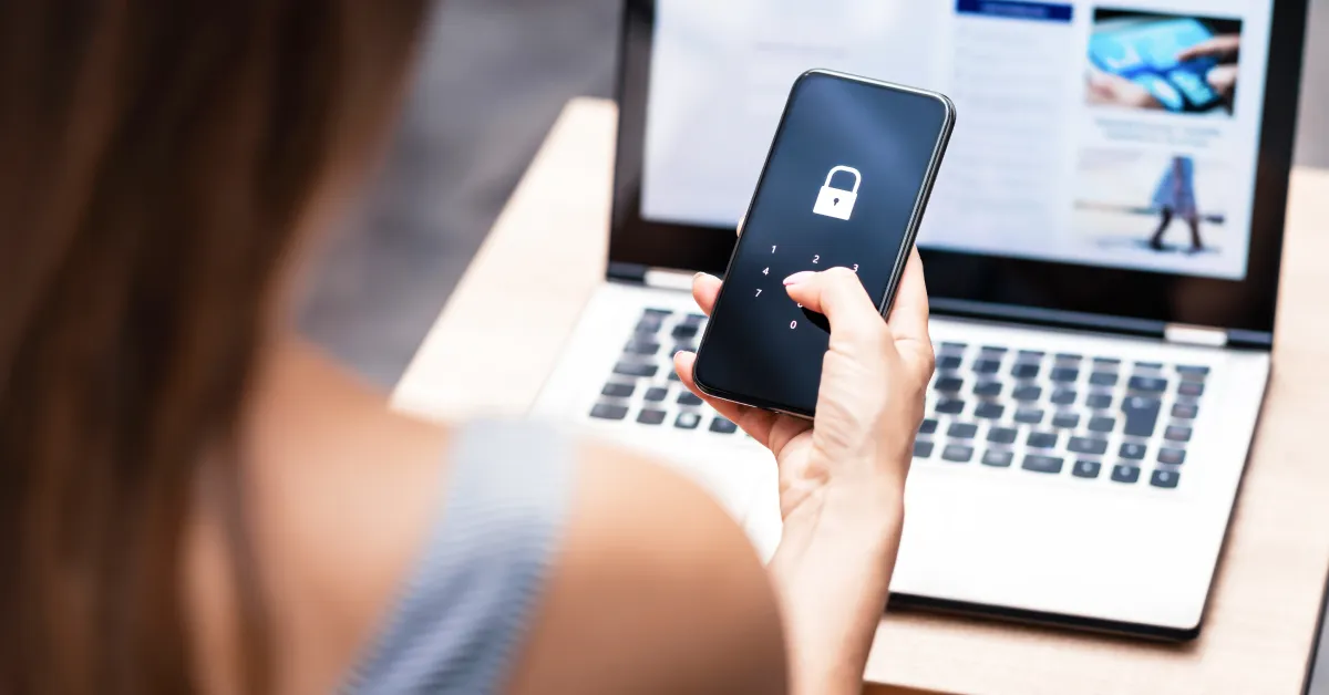Women holding smartphone with lock symbol on display.