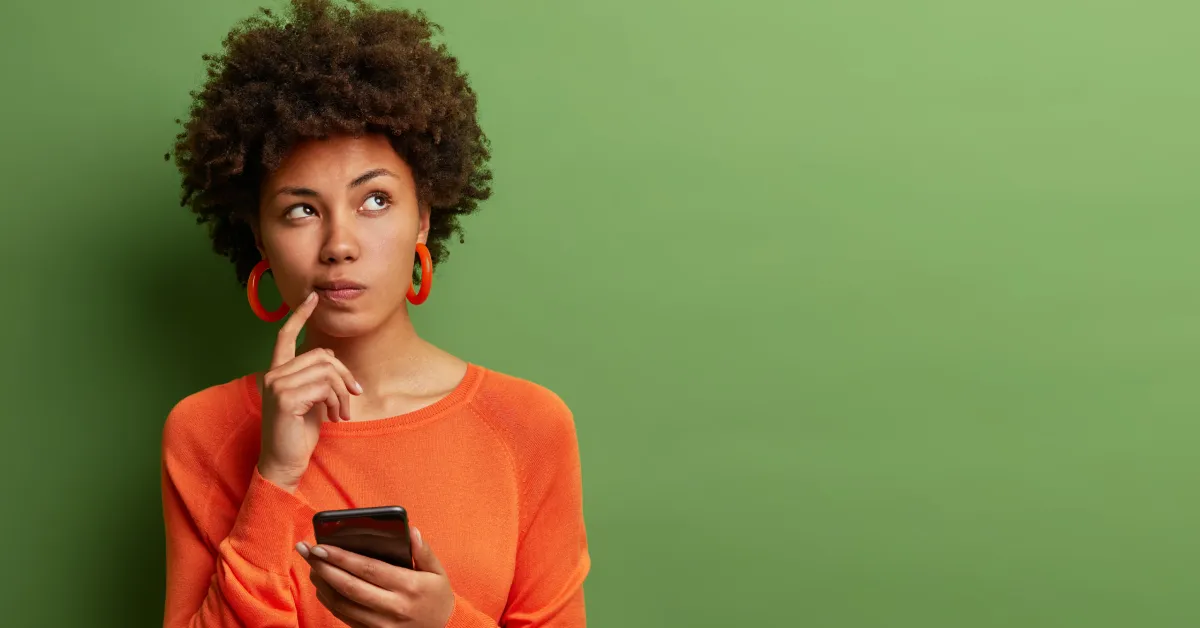 Women inquisitively looking at phone screen.