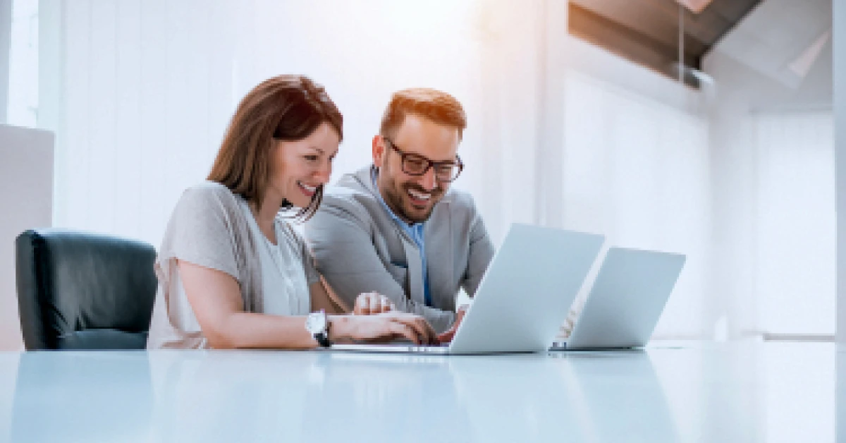 Group of confident business people working with laptop in office.