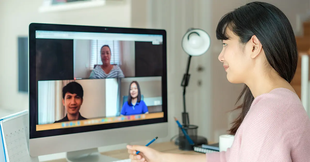 Person talking to coworkers through an online call.