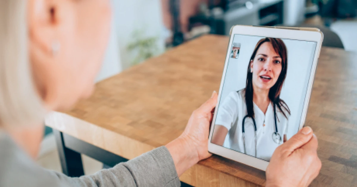 A patient talking to a doctor using digital tablet.