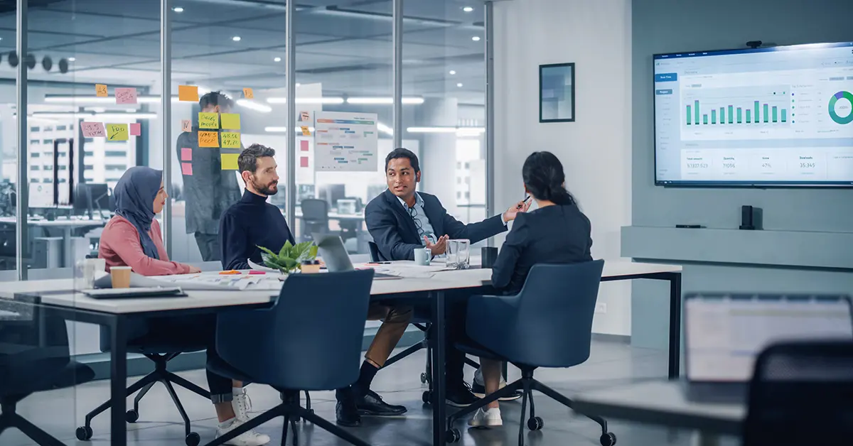 A team discussing around a table in a meeting room.
