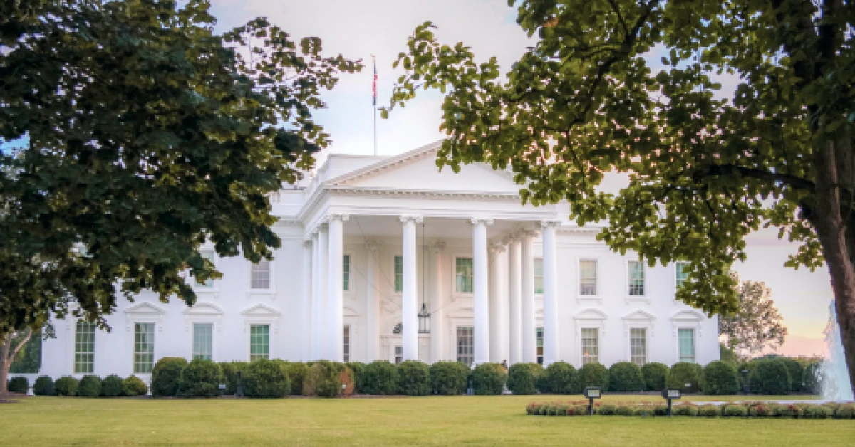 Sunset at the White House see through trees.