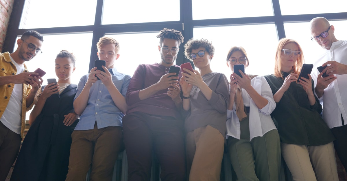Women in an elevator using her smartphone.