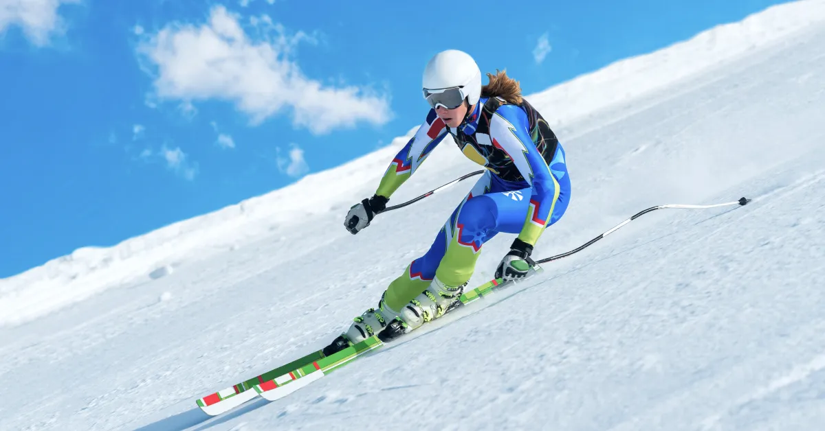 Olympic skier skiing down a steep snowy hill.