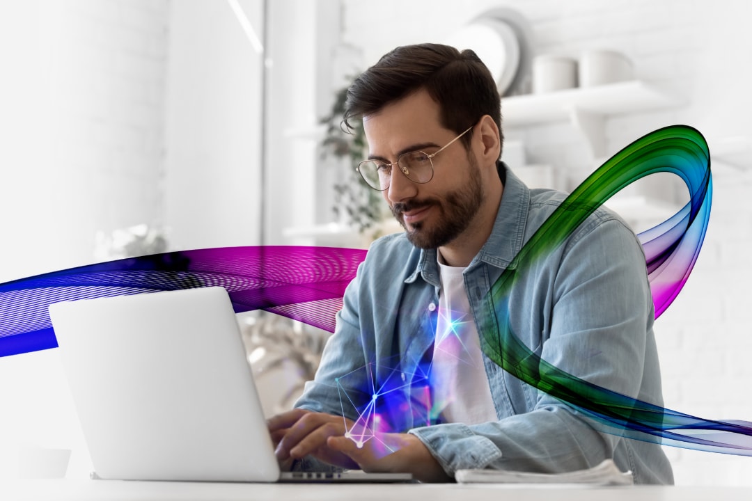 Casual man looking working on a laptop with an abstract colorful ribbon weaving around him