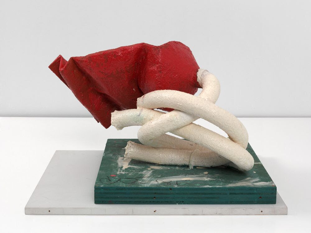 Claes Oldenburg. Tube Supported by its Contents, 1981, paper, urethane foam, metal, vacuum cleaner hose, wood; painted with enamel. 13 1/2 x 19 1/4 x 14 7/8 in. (34.3 x 48.9 x 37.8 cm)