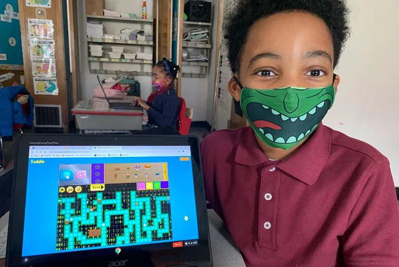 Boy showing his screen of a maze