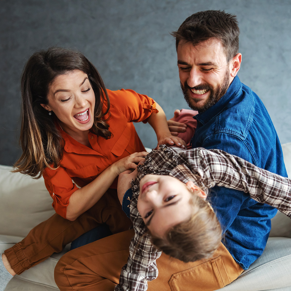 Mother and father playing with child