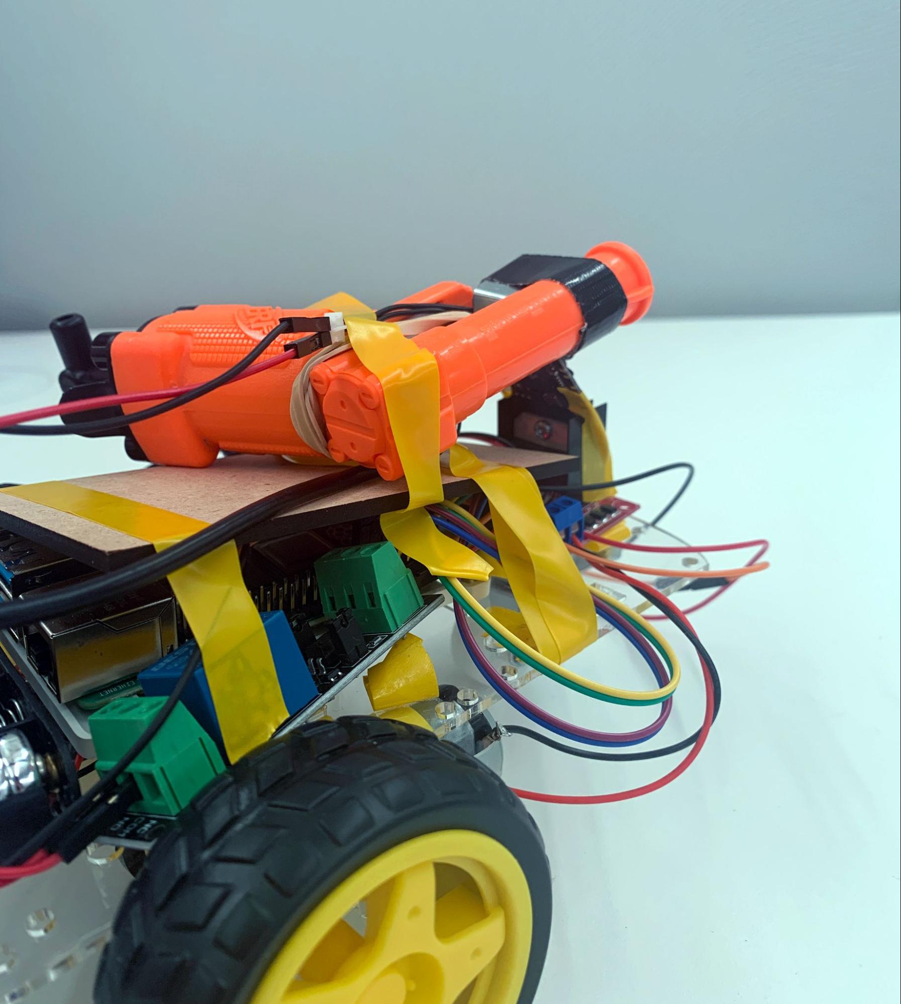 Foam dart launcher taped to a rover base using electrical tape.