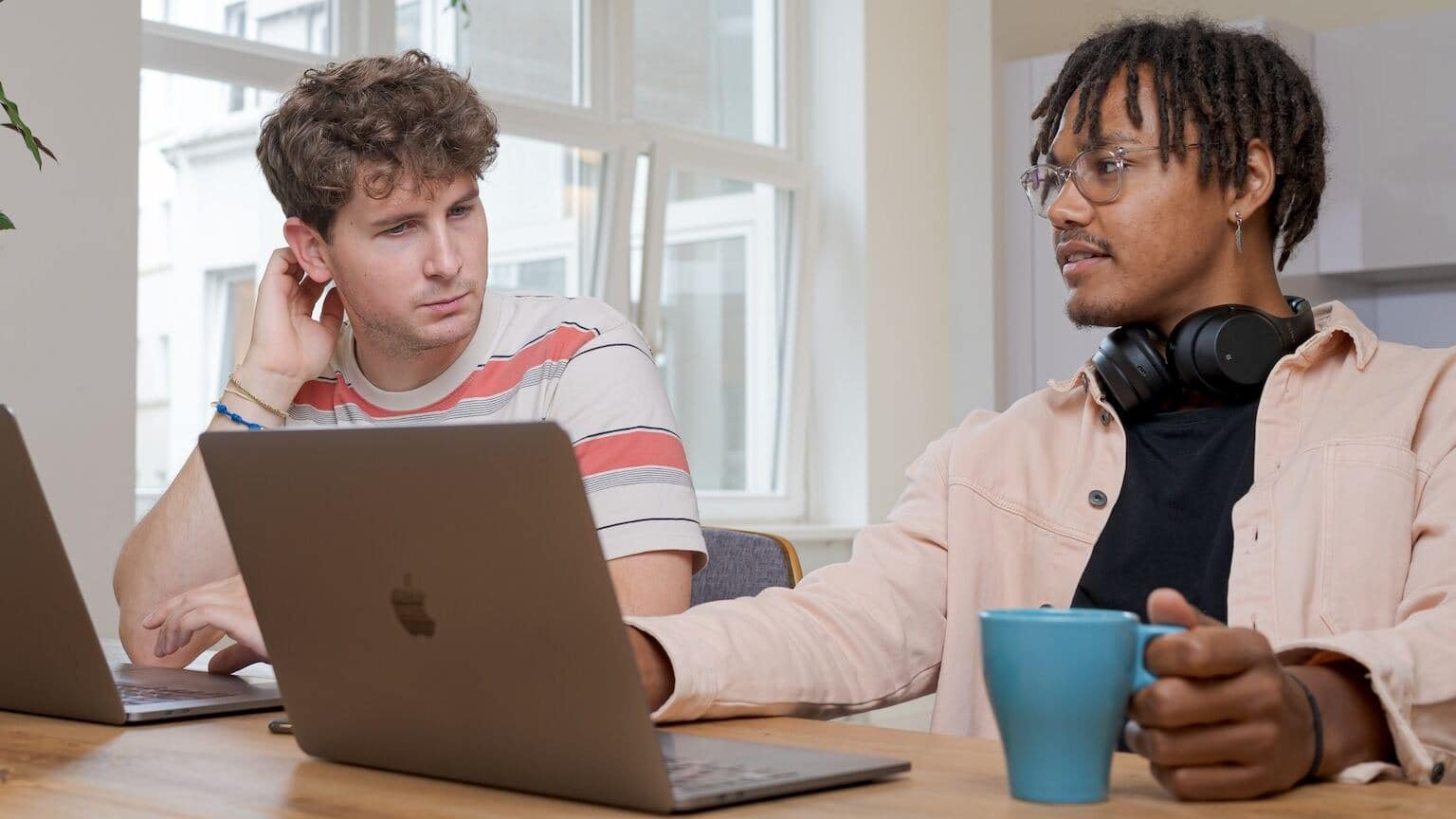 Two men sitting at a table engaged in conversation