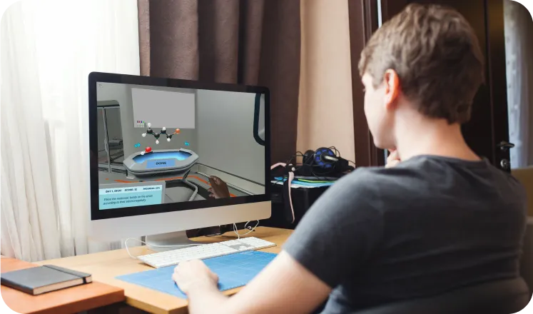 a man sitting in front of a computer monitor