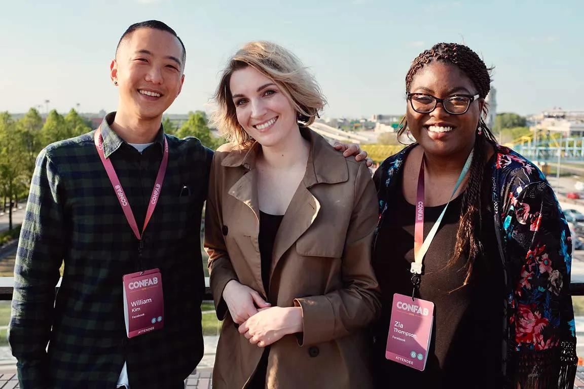 Photo of three happy attendees at the Confab party outside on a nice evening