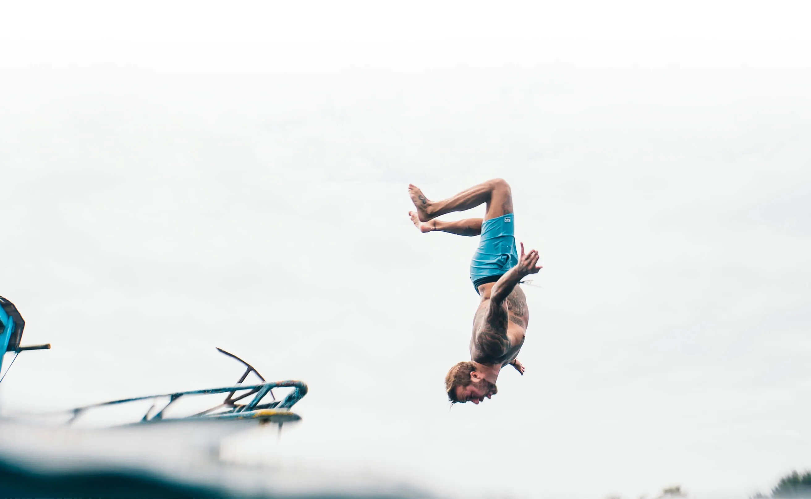 A man diving of a boat into the ocean