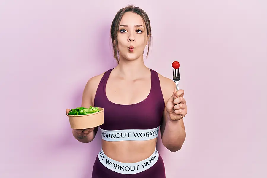 a woman holding two different foods in her hand