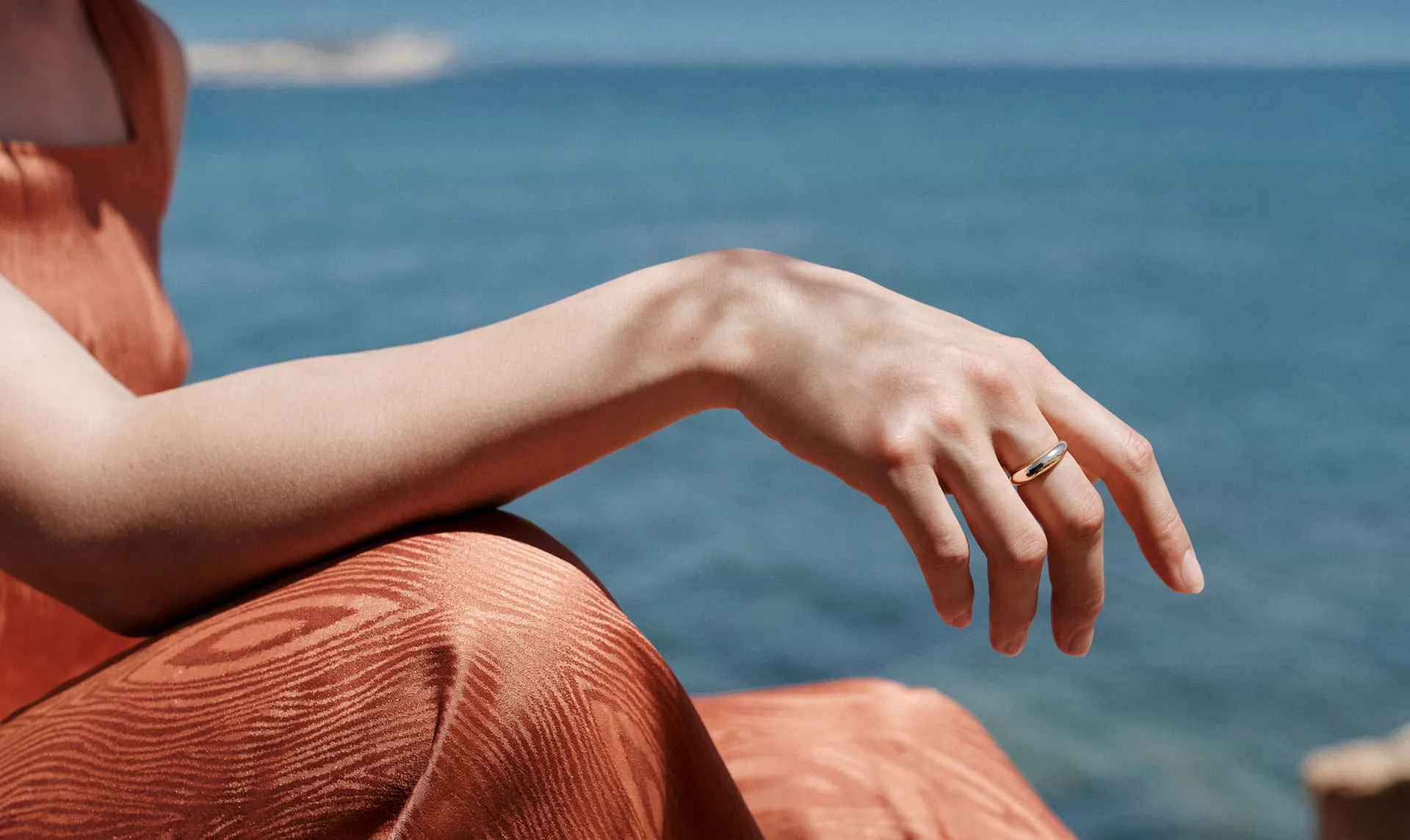 A woman's hand on the sea background