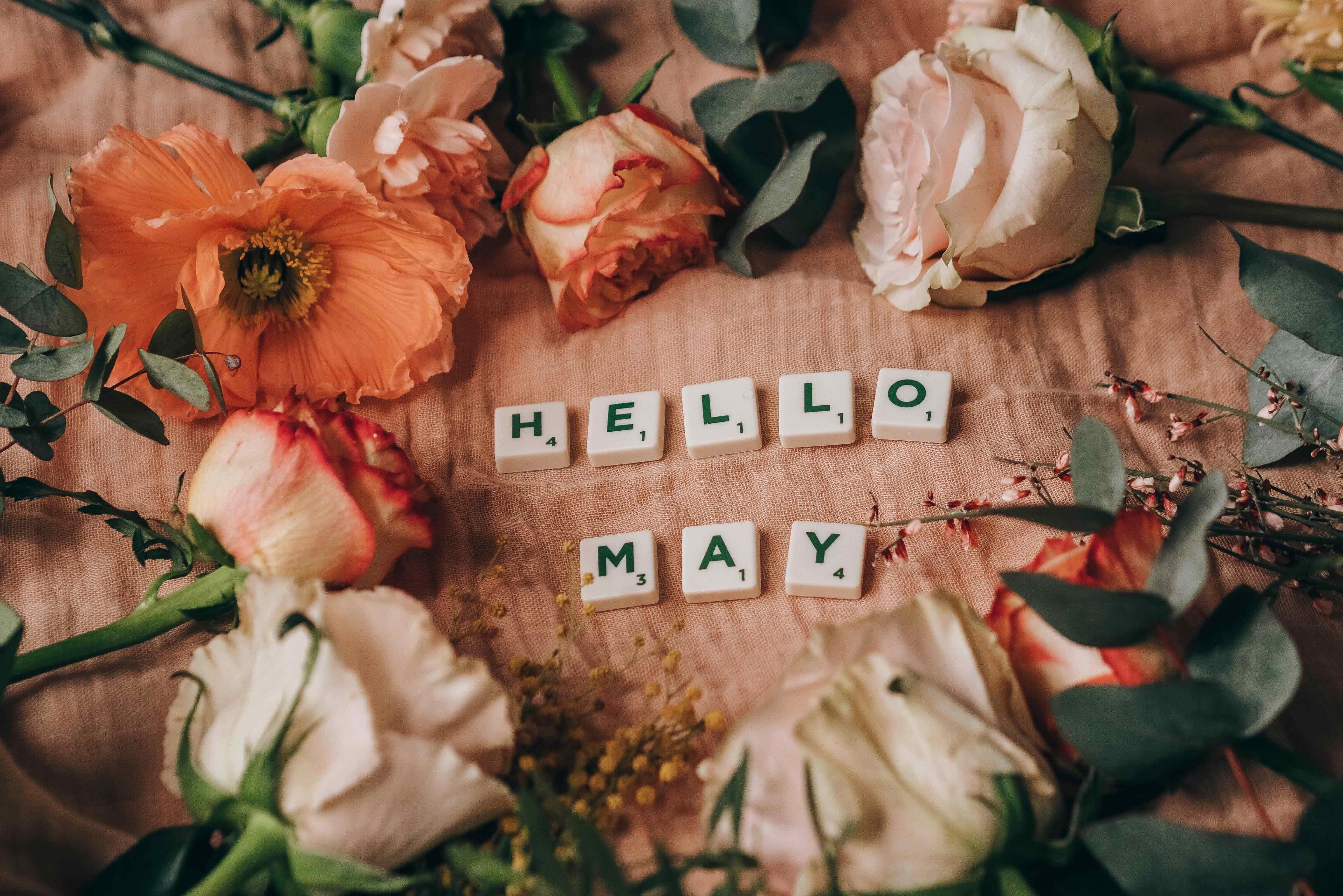 Sign saying 'hello may' to welcome in Mental Health Awareness Month and incorporate happiness into the workforce.