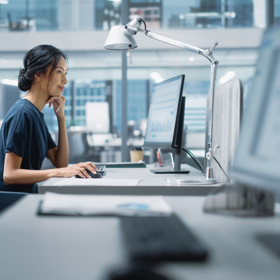 Female staff member using Flexxible software on a Desktop computer