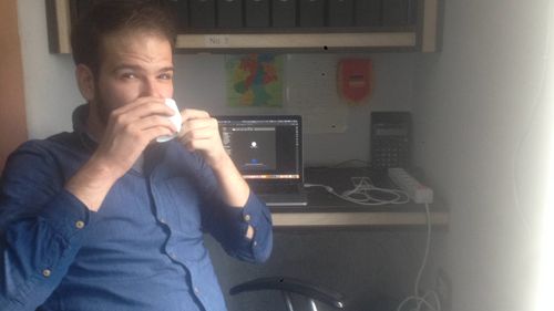 Me drinking coffee in Tanweer's office