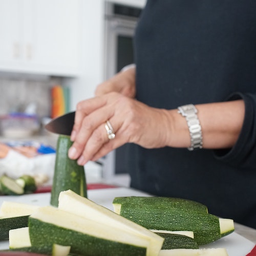 Married woman chopping zucchini
