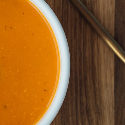 Bowl of vegetable soup on a wooden table