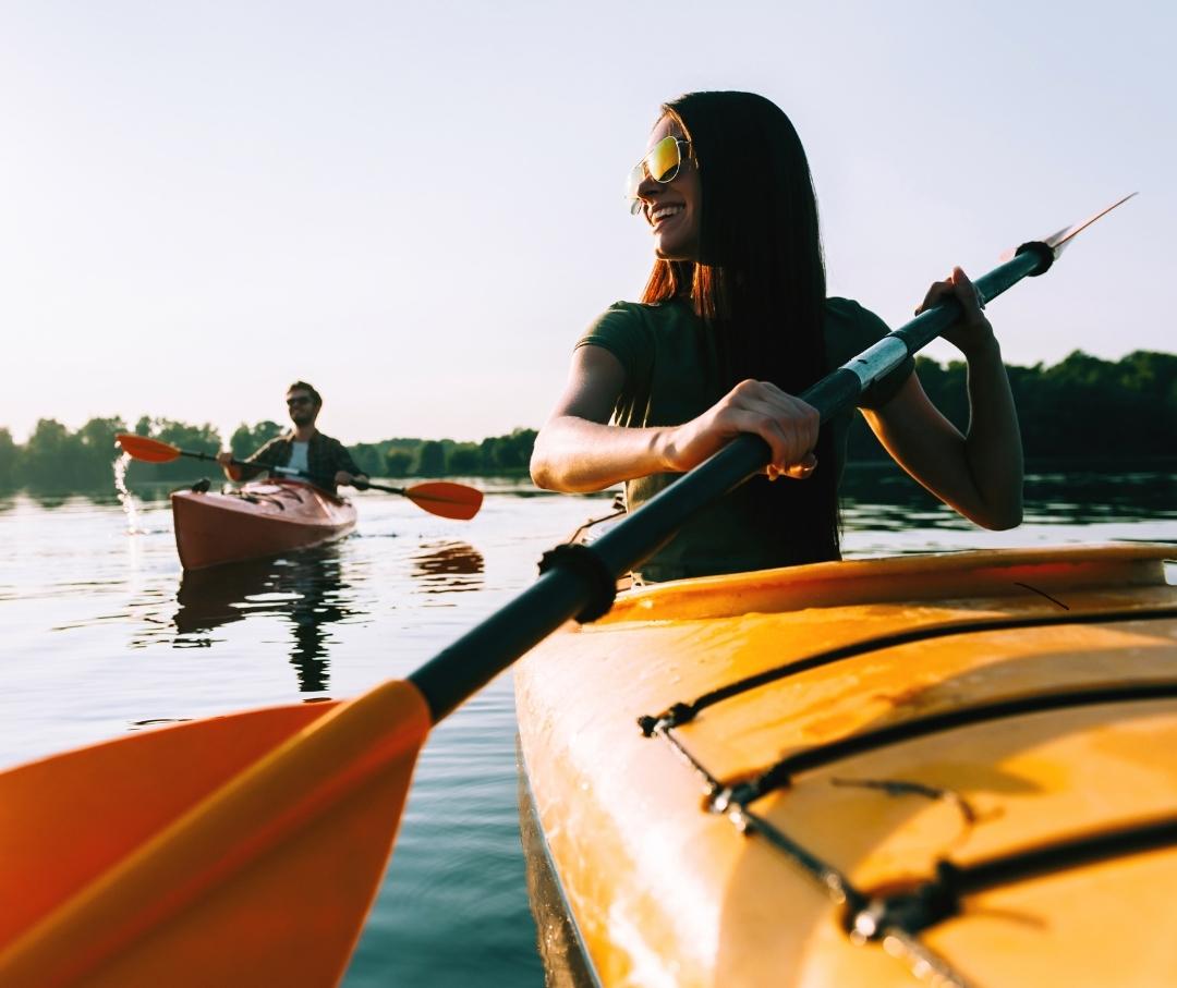 a woman and a man kayaking on a river