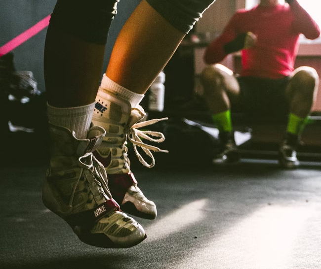 close up shot of person wearing lifting shoes and using a jumprope
