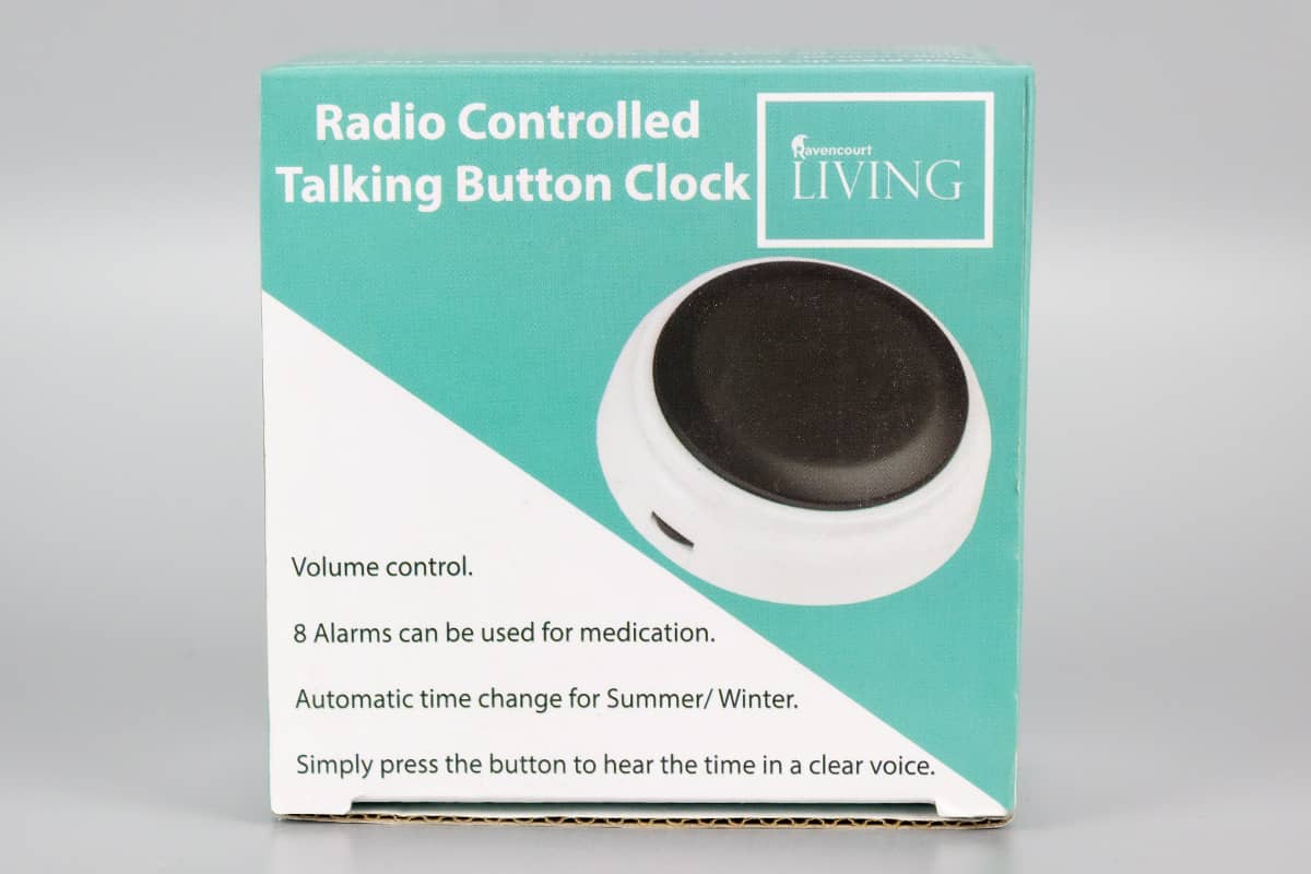 Button clock packaging on grey background