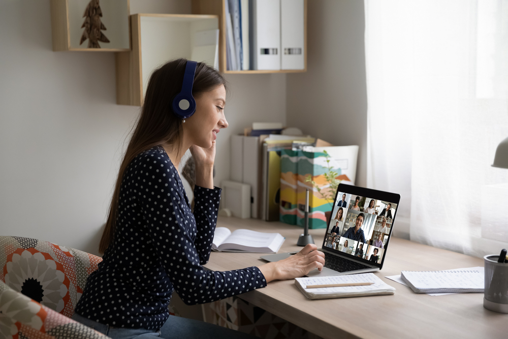 young woman having online study group webcam conversation