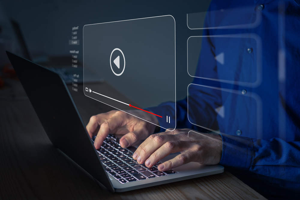 Person watching online movie or TV series on laptop computer screen.