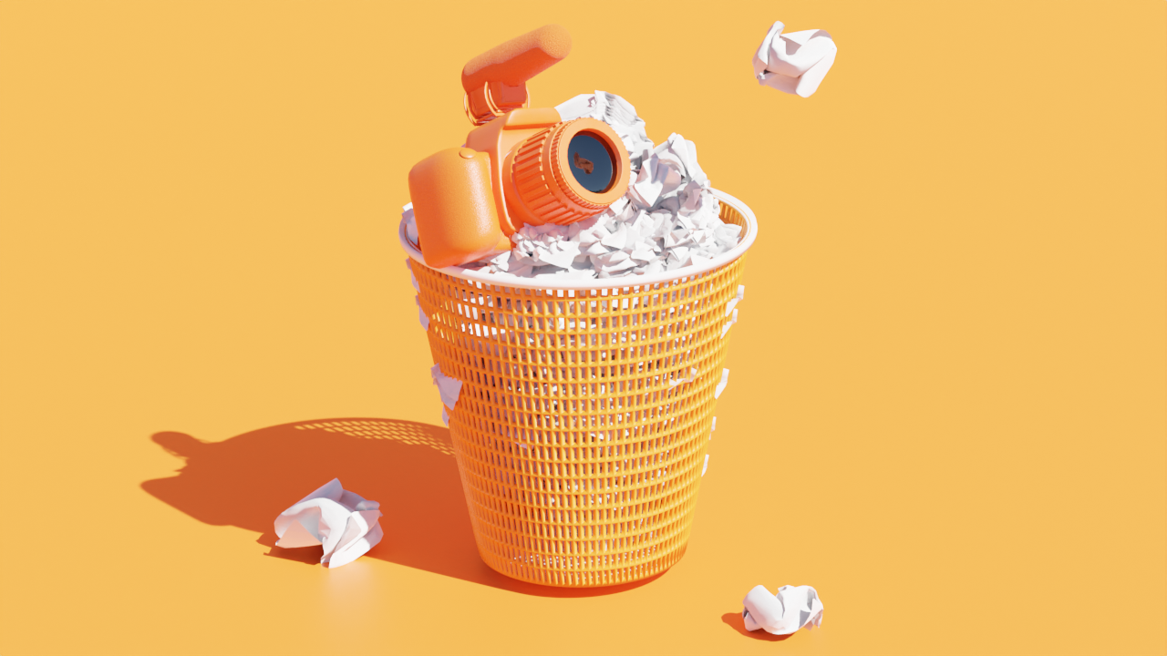 Trash can with a camera atop a mountain of crumpled paper