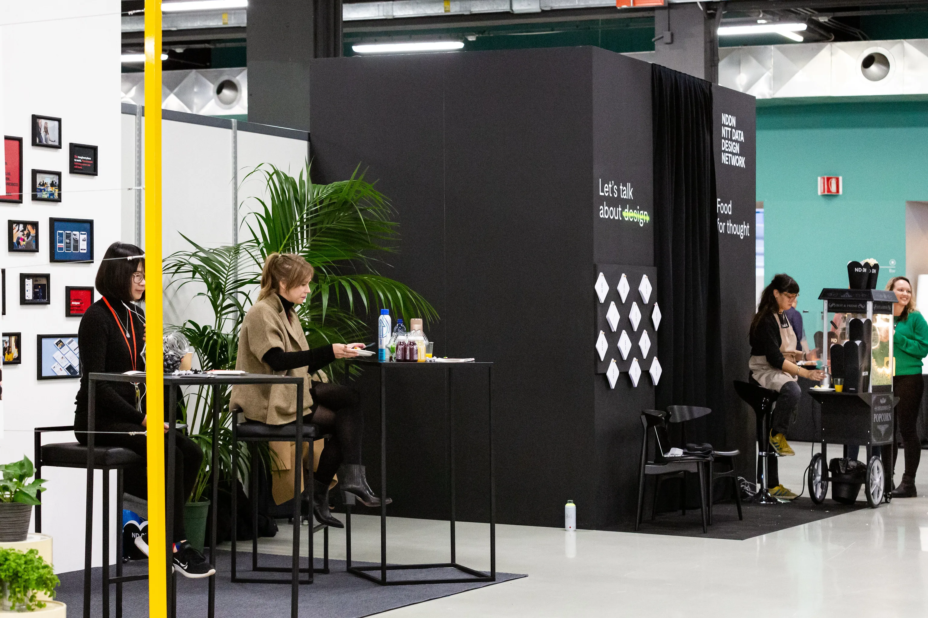 A scene from the exhibition space of the conference. People at the booth are expecting visitors.
