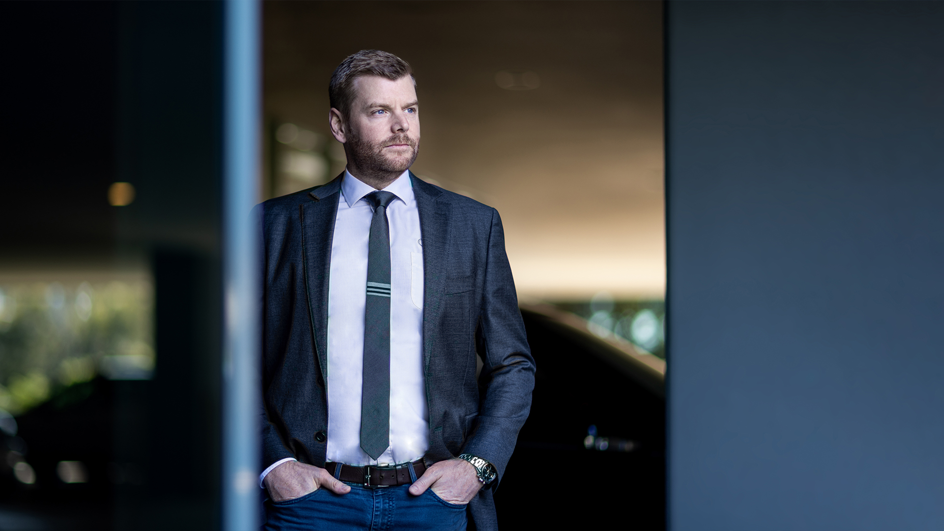 Image of person in suit gazing thoughtfully into the distance