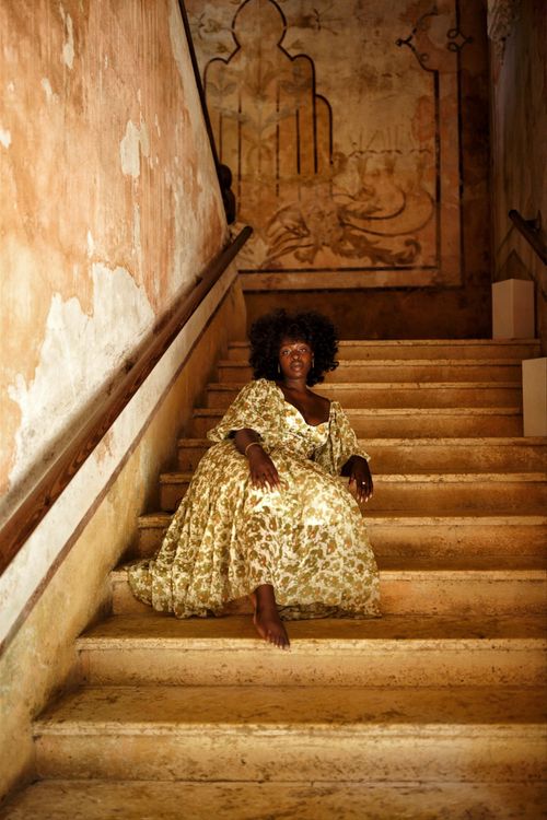 Shade sitting on the antique steps of an old villa in the old city of Cartagena Colombia.