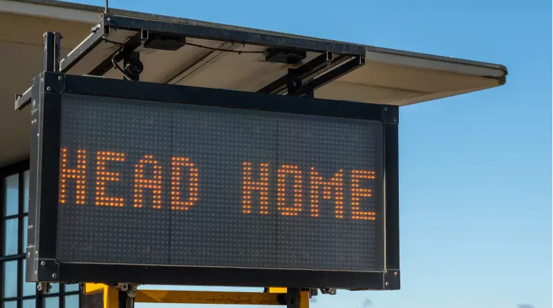 Electronic road sign reading “Head Home”.