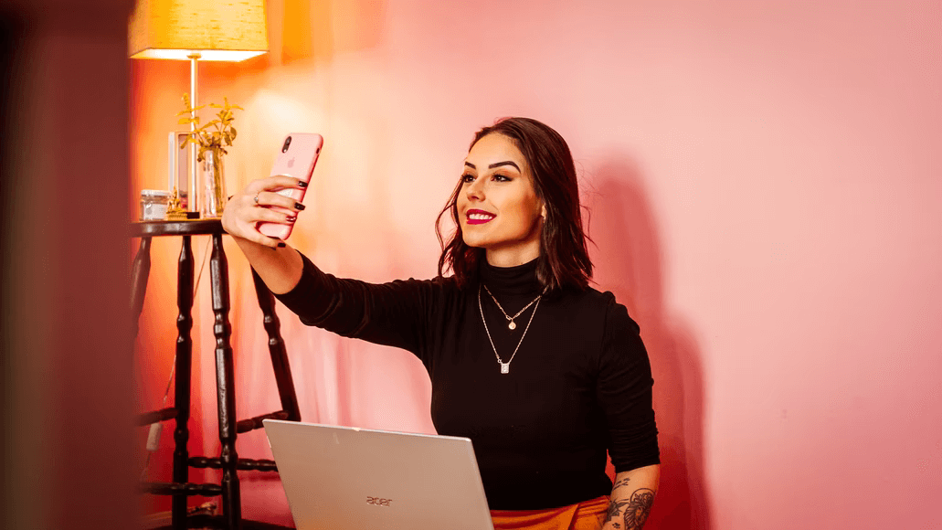 A woman taking a selfie using her smartphone