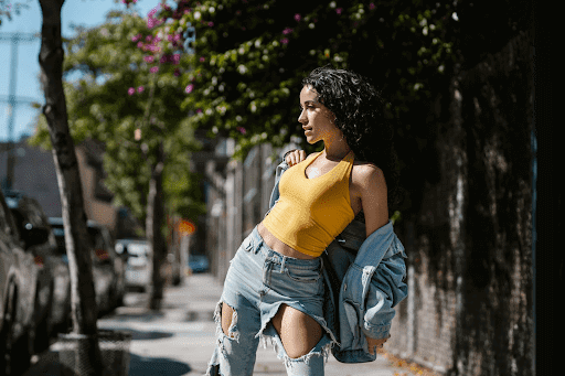 A girl with a curly hair wearing a yellow top